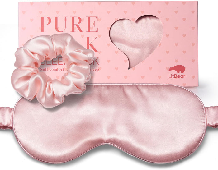 Pink silk sleep mask and matching scrunchie displayed in front of a pink LitBear box with a heart-shaped window.