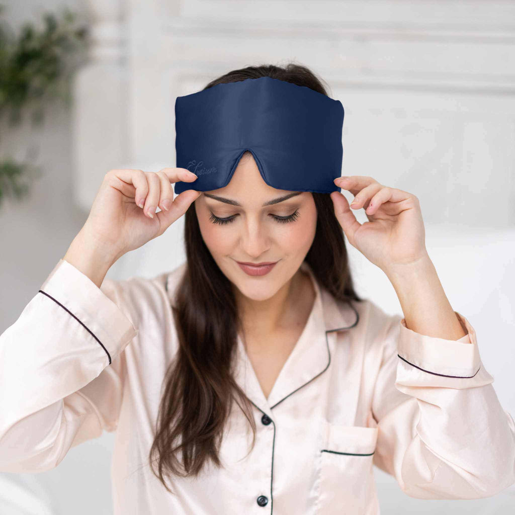 Navy silk sleep set including contoured sleep mask and organic silk bonnet from Soreia, made with 22 Momme silk for comfort.