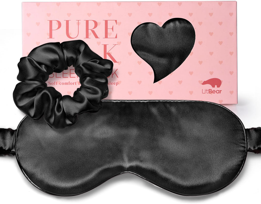 Black sleep mask and gathered black scrunchie shown in front of a pink LitBear box with a heart-shaped window.