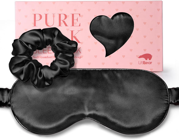 Black sleep mask and gathered black scrunchie shown in front of a pink LitBear box with a heart-shaped window.