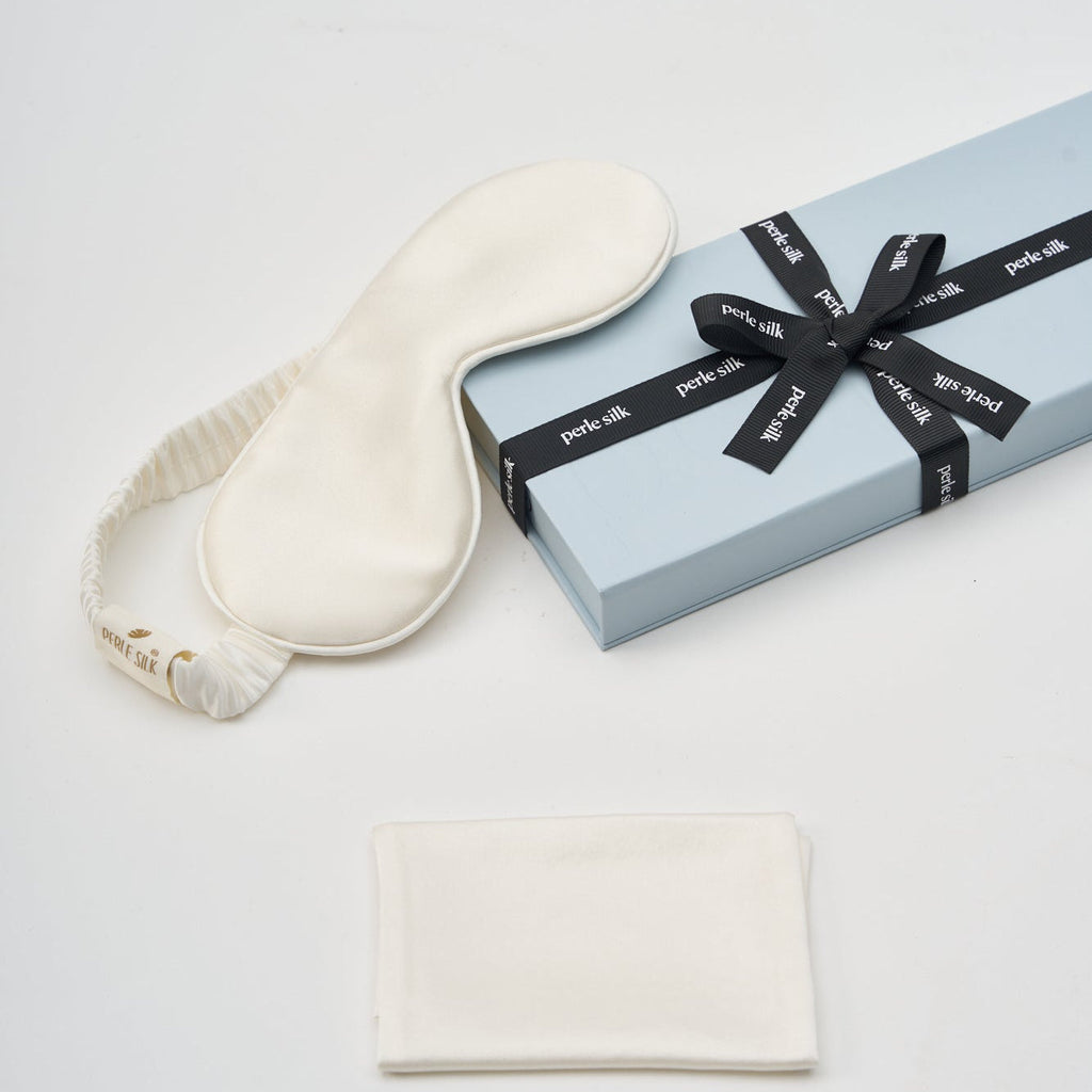 White Charmeuse silk sleep mask by Perle Silk, soft and smooth for comfortable sleep and eye relaxation.