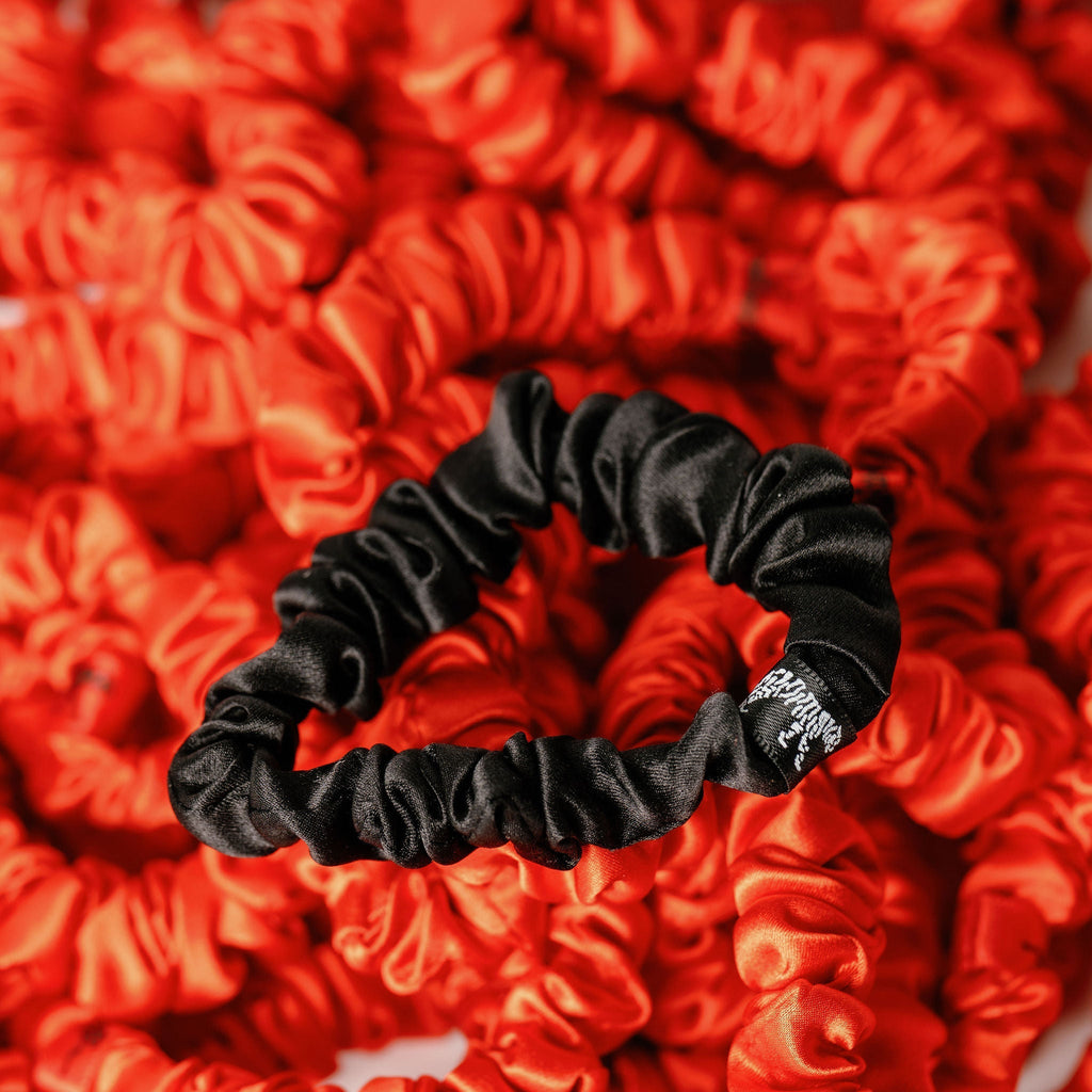 LINA LENNOX organic silk small black scrunchie onyx black with smooth, shiny fabric, suitable for hair styling or accessories.