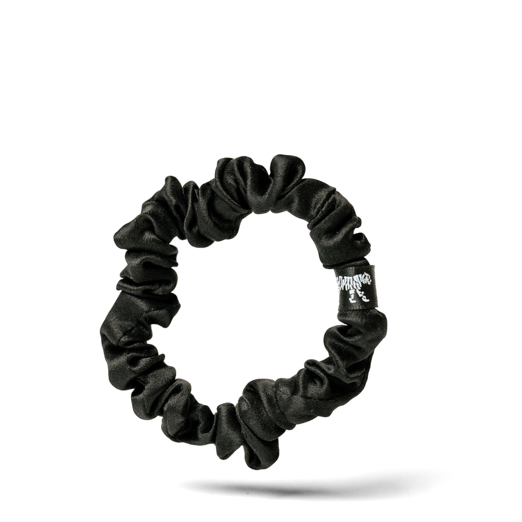 Organic silk small black scrunchie from LINA LENNOX with a soft, glossy finish, shown on a white background.