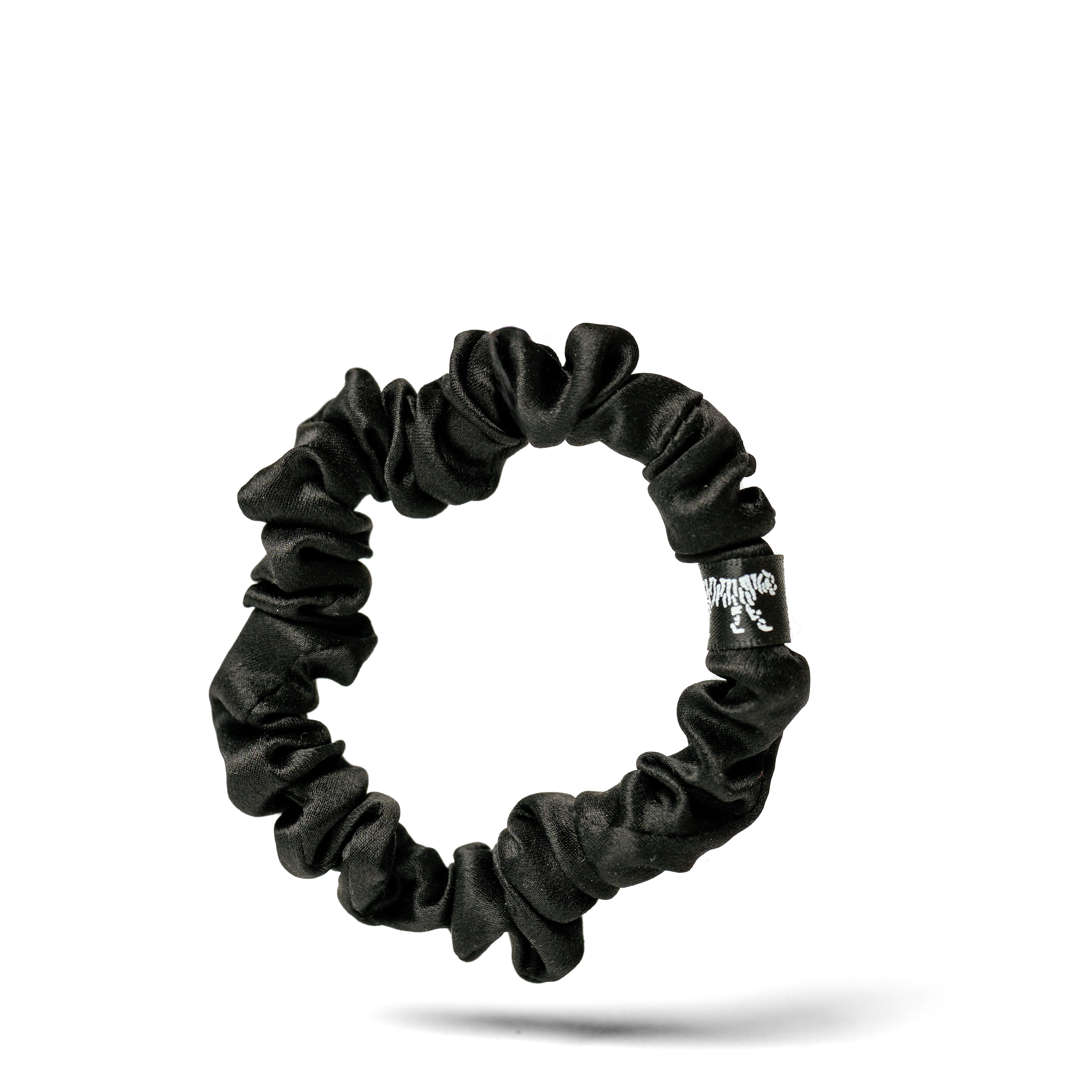 Organic silk small black scrunchie from LINA LENNOX with a soft, glossy finish, shown on a white background.