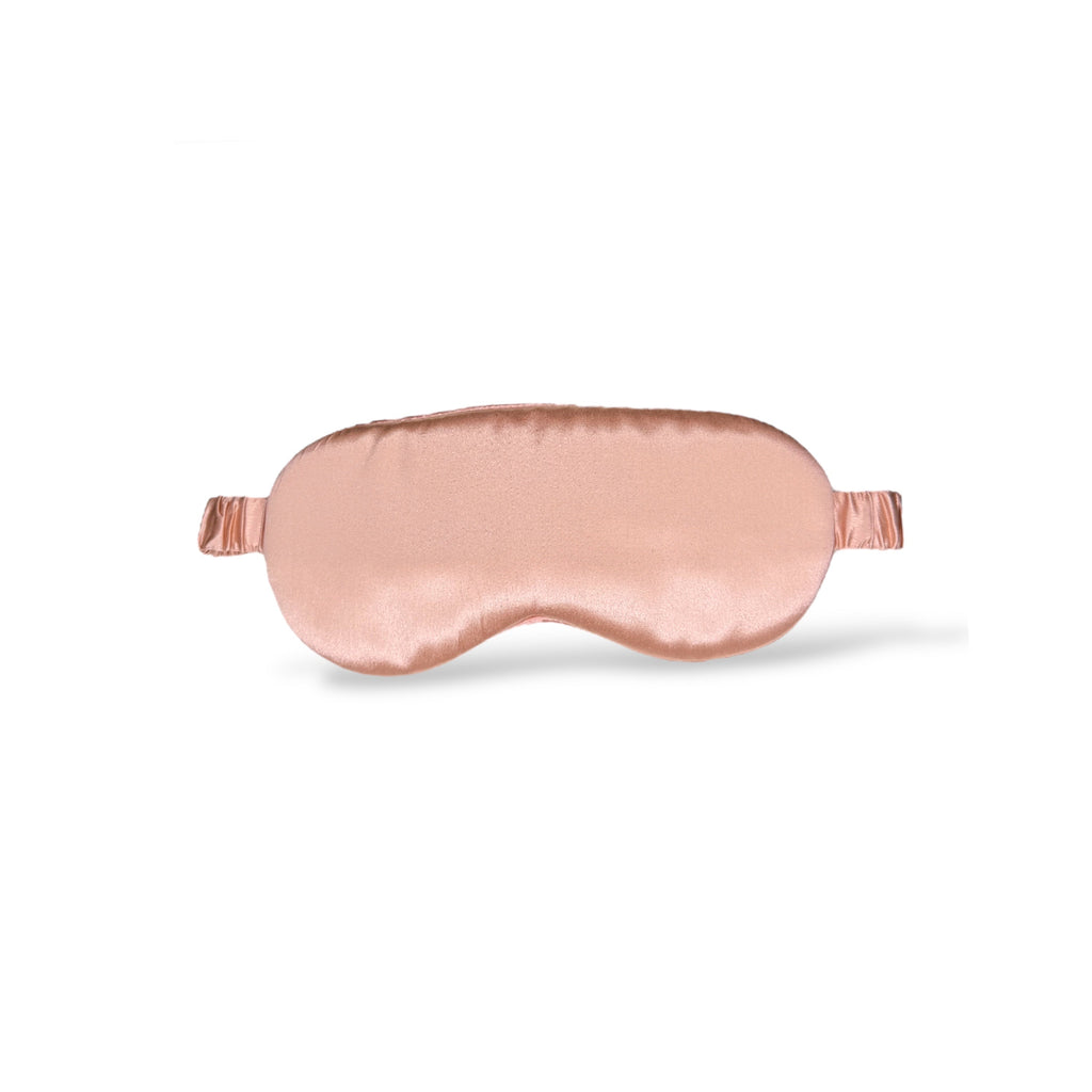 Black silk sleep mask with rose gold accents, blackout design, 22 Momme for luxurious comfort by Soreia.