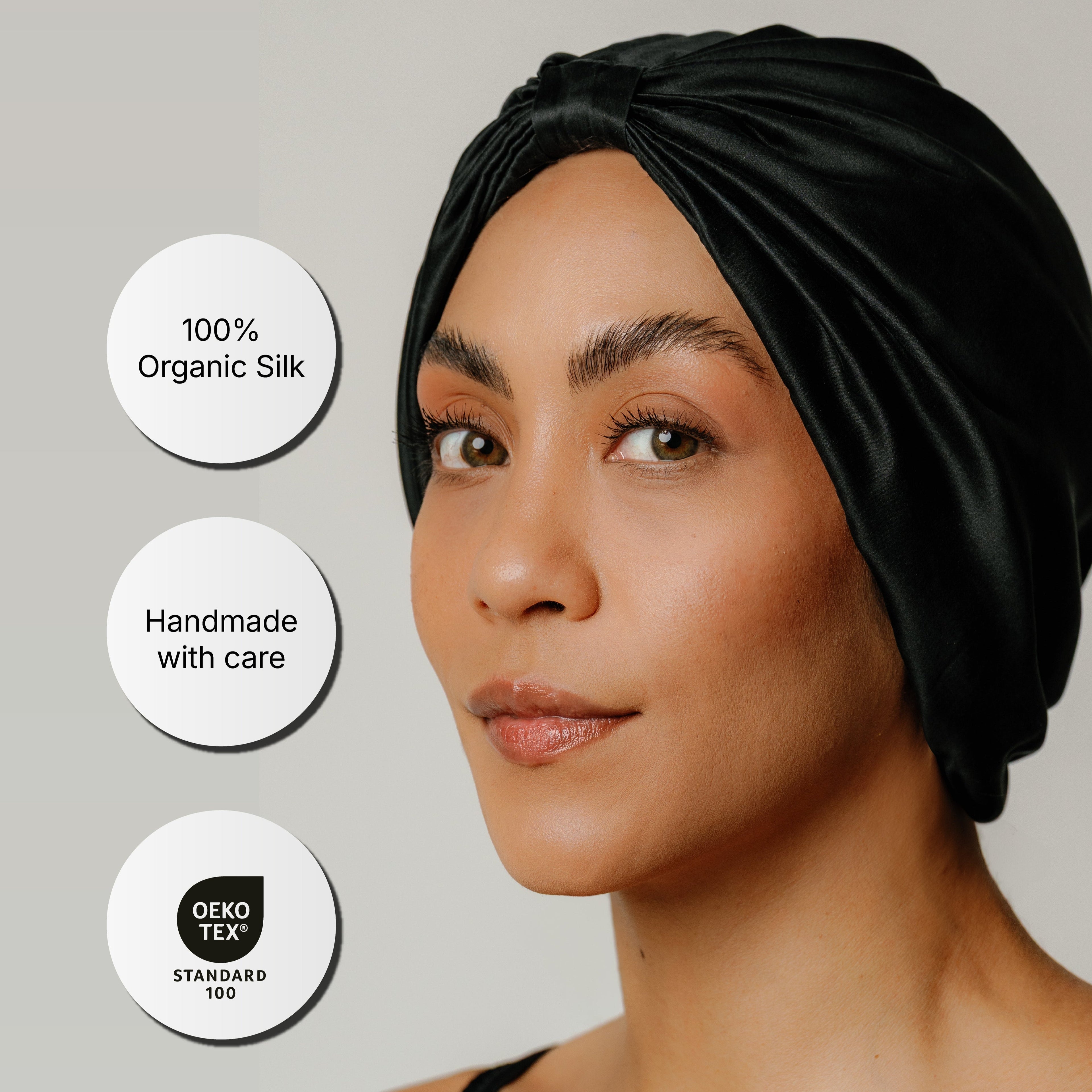 Onyx black Soreia organic silk sleep bonnet made from 22 Momme mulberry silk, featuring a smooth, luxurious hair accessory.