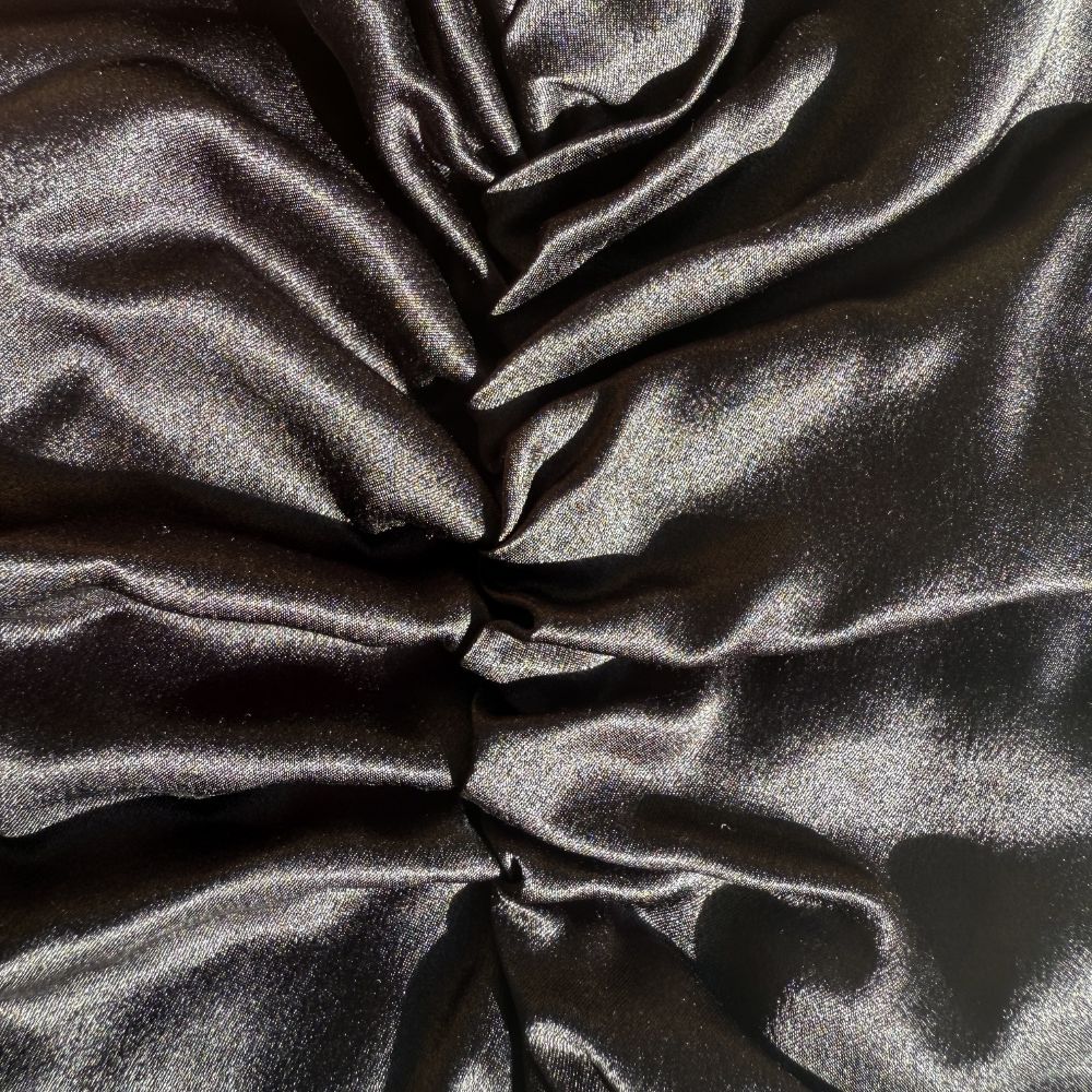 Organic black silk sleep bonnet by Soreia, made from 22 Momme Mulberry silk, designed to protect hair overnight.