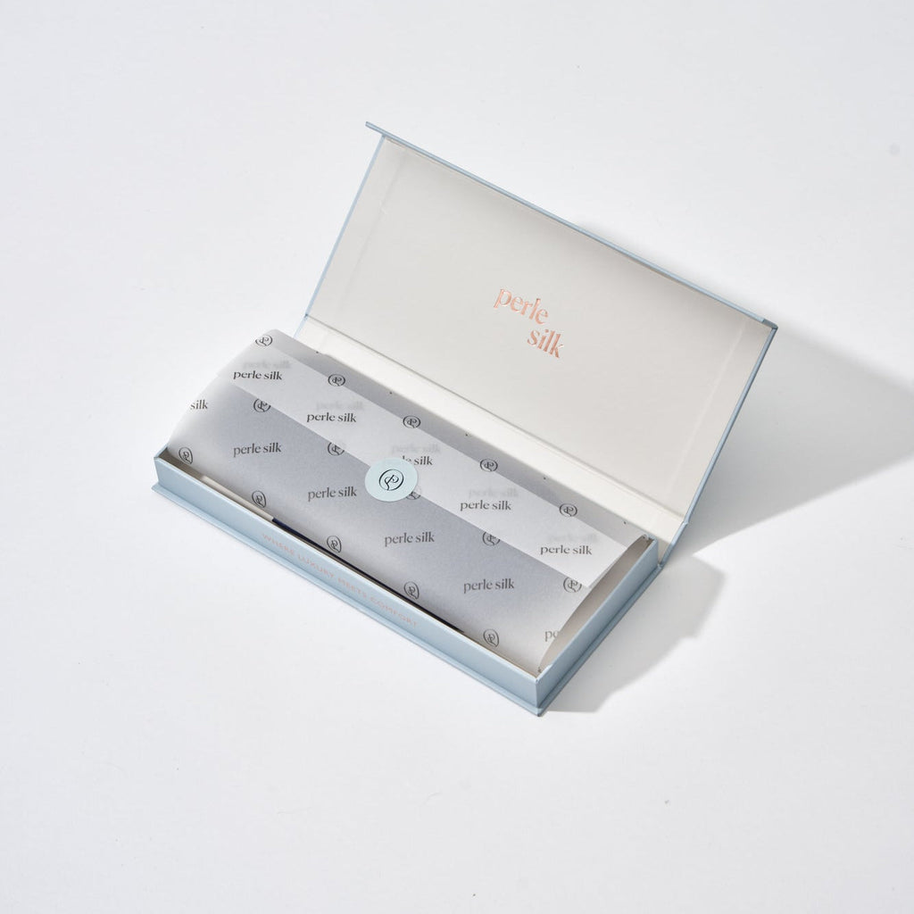 Perle Silk Charmeuse Silk Sleep Mask in a gift box, soft and luxurious for restful sleep and skin care.