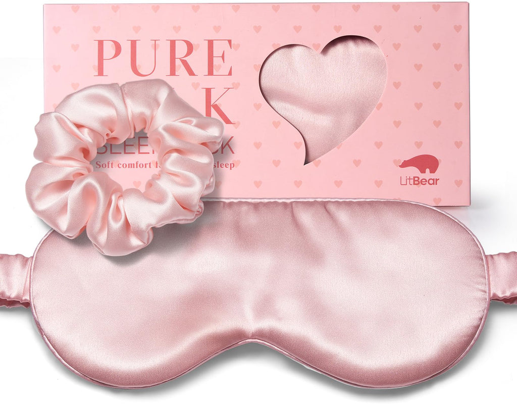 Pink silk sleep mask and matching scrunchie displayed in front of a pink LitBear box with a heart-shaped window.