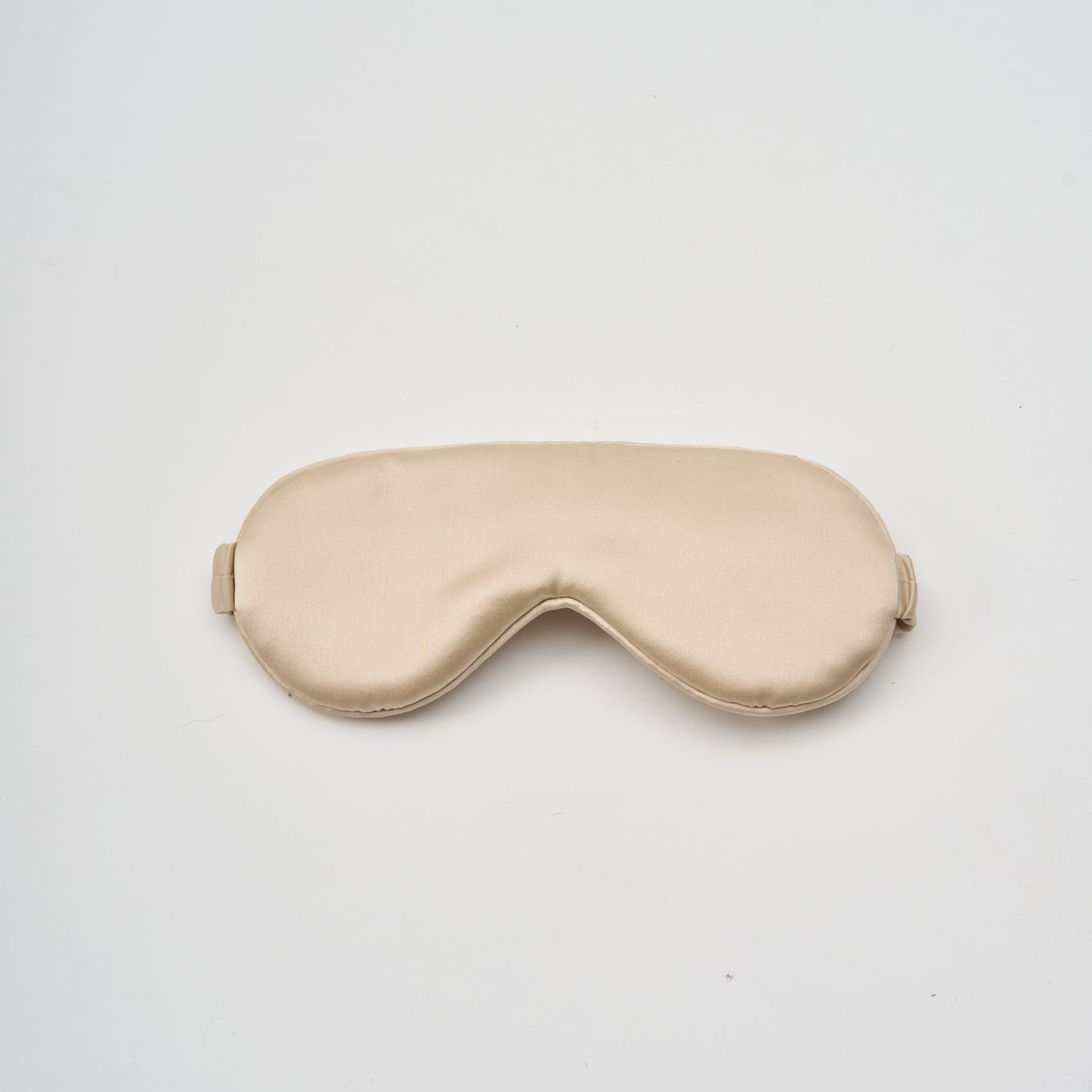 Champagne-colored charmeuse silk sleep mask by Perle Silk, soft and smooth Mulberry silk for restful nights.