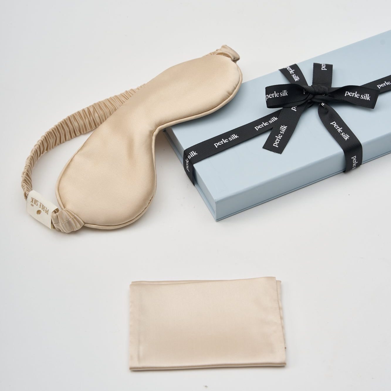 Champagne-colored Perle Silk charmeuse silk sleep mask with smooth, luxurious fabric for comfortable sleep.