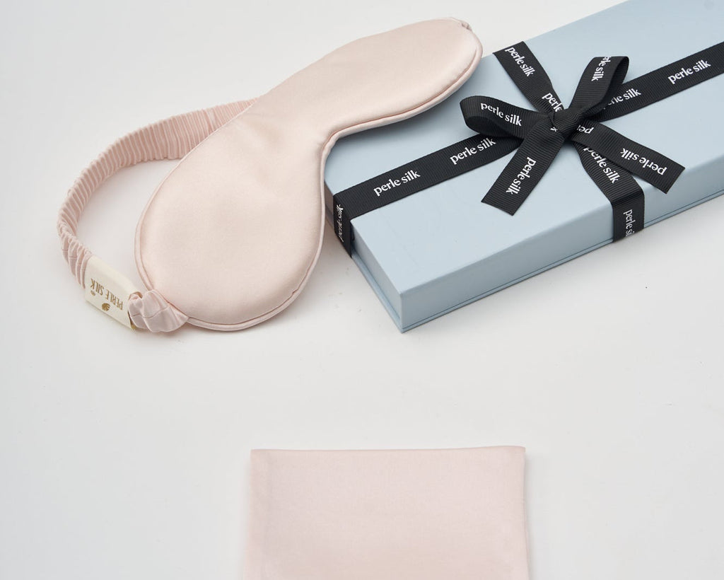 Blush-colored charmeuse silk sleep mask by Perle Silk, soft and smooth for restful sleep and skin comfort.