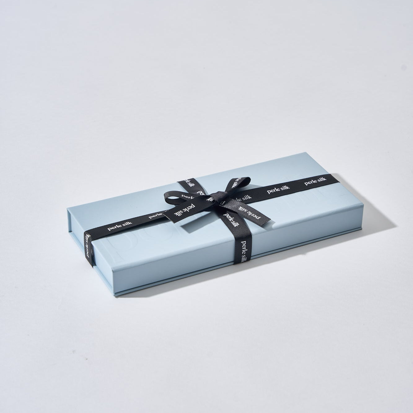 Perle Silk charmeuse silk sleep mask in a gift box, soft and luxurious for comfortable nighttime rest.