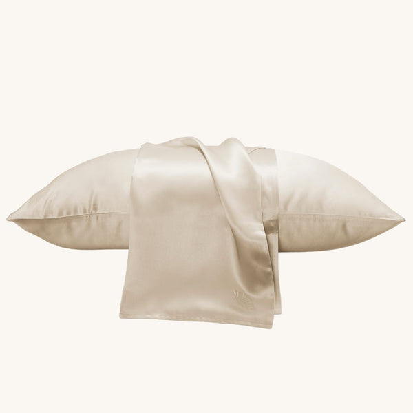 Luxurious champagne silk pillowcase by Soreia, 22 Momme charmeuse embroidered mulberry silk for smooth, elegant sleep.