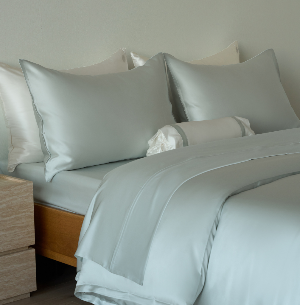 Close-up of Soreia Charmeuse Silk Flat Sheet in sky blue, showing smooth, luxurious mulberry silk fabric with a subtle sheen.
