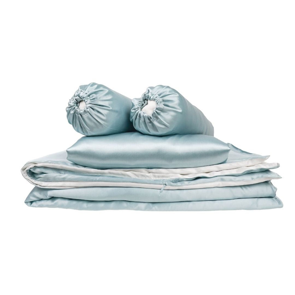 Soft pink silk baby gift set from Soreia, featuring a baby blanket, hat, and mittens in a coordinated bundle.