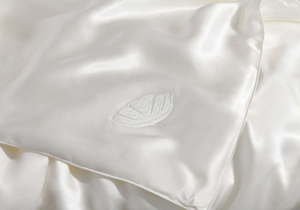 All season silk comforter by Soreia with Grade 6A mulberry silk fill, shown in summer weight at corner view.