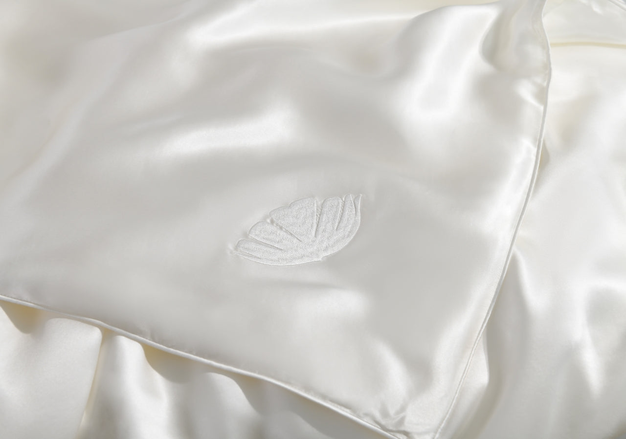 All season silk comforter by Soreia with Grade 6A mulberry silk fill, shown in summer weight at corner view.